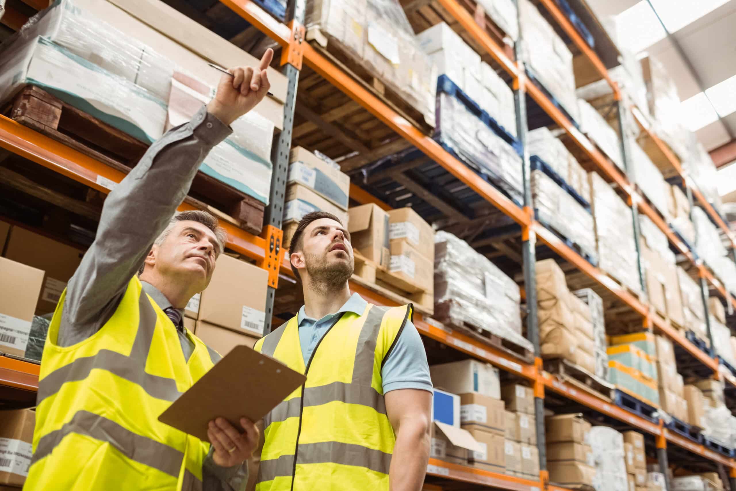 A warehouse member pointing at a product