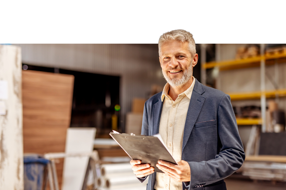 A portrait of a man checking his warehouse inventory